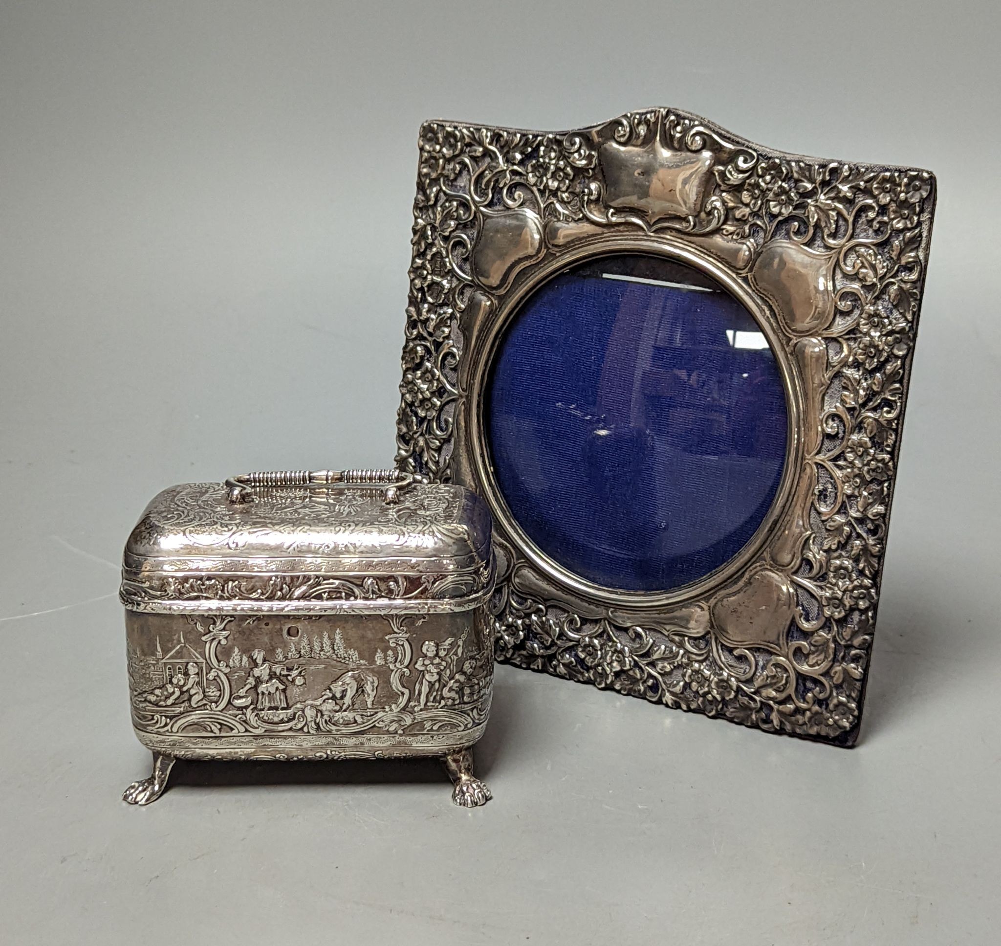An Edwardian repousse silver mounted photograph frame, Birmingham, 1901, 15.8cm and a small white metal casket.